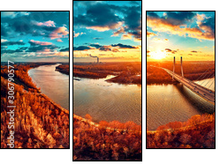 Beautiful panoramic aerial drone view to cable-stayed Siekierkowski Bridge over the Vistula river and Warsaw City skyscrapers, Poland in gold red autumn colors in November evening at sunset - Dreiteiliges Leinwandbild, Triptychon