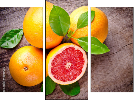 Freshly harvested grapefruit on wooden background - Dreiteiliges Leinwandbild, Triptychon