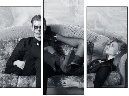young man and woman on the sofa. makeup in Halloween theme - Dreiteiliges Leinwandbild, Triptychon