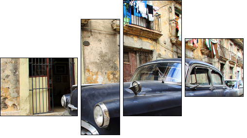 A classic old car is black color parked in front of the building - Vierteiliges Leinwandbild, Viertychon